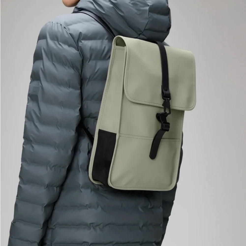 rains olive backpack Rolltop Rucksack- Green mesh back panel and adjustable compression shoulder straps Rains® Clip Front Backpack in